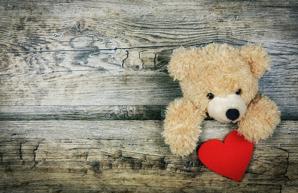 Stuffed bear holding a red heart 